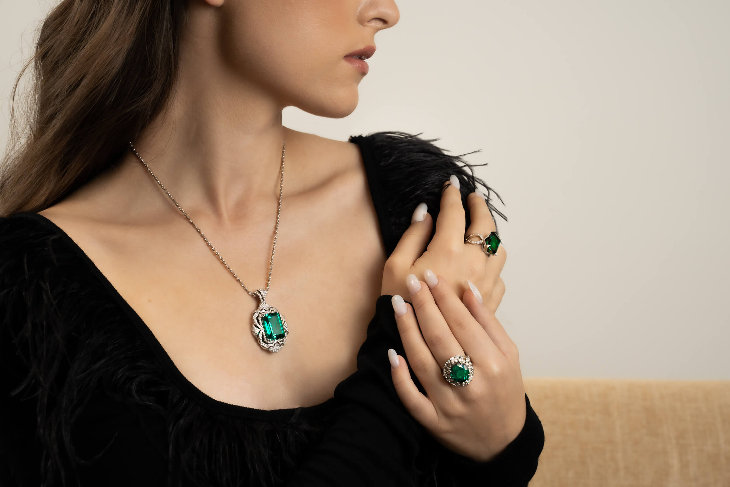 Woman wearing emerald rings and necklace